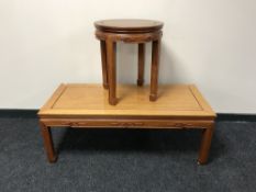 A rectangular low coffee table with matching circular lamp table in an Oriental style