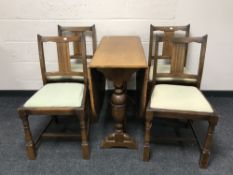 An oak drop leaf table together with four chairs (odd)