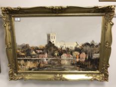 A gilt framed oil on canvas - river scene with church beyond,