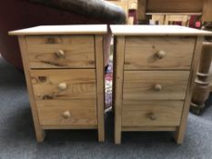 A pair of pine three drawer bedside chests,
