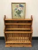 A pine plate rack together with a small oil painting depicting still life with flowers