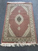 An Isfahan design rug on pink ground,