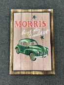 A hand painted Morris Minor sign on a pine board