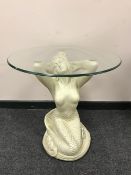 An ornate 'Mermaid' circular glass topped lamp table, diameter 61 cm.