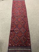 A Meshwani runner on red ground,