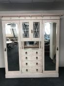 A late Victorian painted mirror door wardrobe fitted with drawers