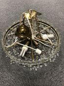 A circular contemporary light fitting with cut glass drops