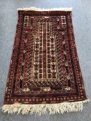 An Afghan prayer rug on red ground,