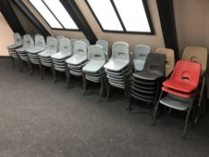 Approximately one hundred and twenty three plastic stacking chairs