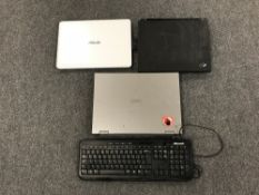 A box containing three laptops, Toshiba, Asus and IBM,