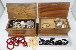 A pair of oak jewellery boxes containing : a jet bead necklace (needs restringing),