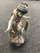 A Lladro figure of a geisha CONDITION REPORT: The flower in the geisha's hand