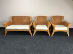 A pine and wicker three piece conservatory suite