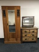 An Arts and Crafts pine mirror door wardrobe,