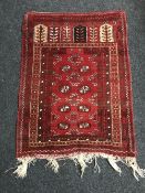 An Afghan prayer rug on red ground