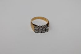An 18ct gold eight stone diamond ring in square setting, size E, 3.7g.