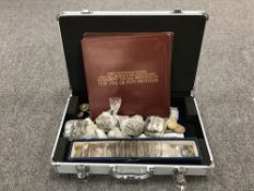 An aluminium case of Danbury Mint crown covers.