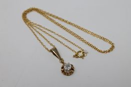 A single diamond pendant on silver gilt chain