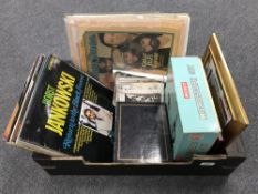 A box of LP records, two albums of bundle of postcards, microscope set,