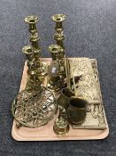A tray containing two relief panels, brass measures, brass trivet,