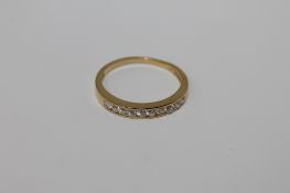 A silver gilt half eternity ring set with cz