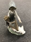 A Lladro figure - girl protecting a boy