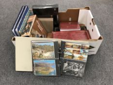 A box of nine post card albums and a scrap album of cigarette pack advertisements