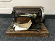 A mid twentieth century oak cased Singer hand sewing machine