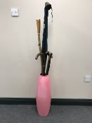 A stick stand containing a three piece fishing rod, assorted walking sticks and canes,