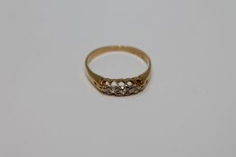 An 18ct gold five stone diamond ring, size O, 2.7g.