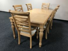 A contemporary extending dining table on reeded legs, together with six chair,