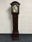 A Tempus Fugit granddaughter clock with a brass dial