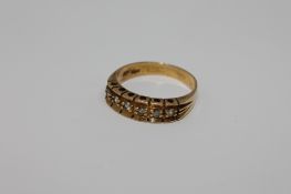 An 18ct gold six stone diamond ring, size P/Q, 4.5g.