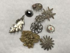 Ten silver brooches (10)