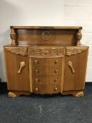 A carved oak buffet backed sideboard