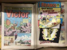 A box containing assorted Beano and Victor comics,