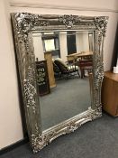An ornate silvered framed mirror, 123 cm x 155 cm.