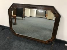 An early twentieth century large oak octagonal bevel edged wall mirror