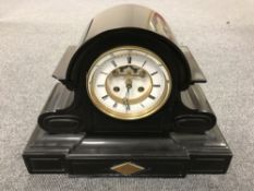 A late nineteenth century slate mantel clock, with enamelled dial,