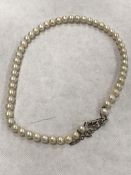 Fine quality strap of graduated pearls on a white gold diamond clasp