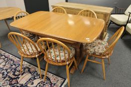 ** LOT DESCRIPTION CHANGE ** An Ercol light elm extending refectory style table,