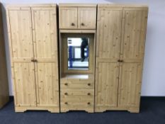 A three piece pine effect bedroom unit