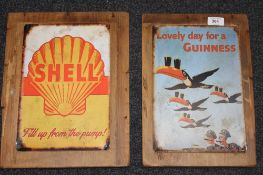 Two metal advertising signs mounted on pine boards,