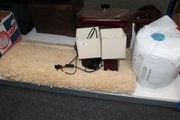 A contemporary rug together with a three way floor lamp,