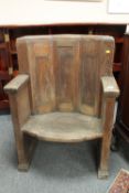 A pair of early twentieth century oak armchairs,