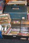 A box containing LP's, CD's, boxsets, romance, country, Vietnam DVD boxset,