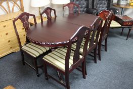 A twin pedestal extending dining table with leaf,