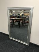 A contemporary silvered framed bevel edged mirror