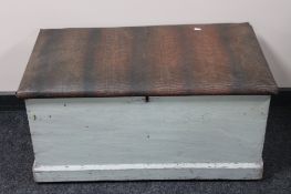 A painted antique pine blanket box with cushion top