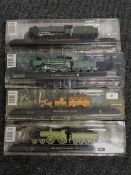 Four model trains on stands including Stephenson's Rocket